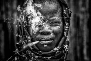 Trademark Fine Art Canvas Wall Art - Joxe Inazio Kuesta 'Laarim Woman Smoking South Sudan' Wall Art for Living Room, Bedroom, or Office Décor